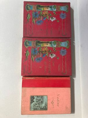 trois boîtes rouges sont empilées les unes sur les autres sur une surface blanche