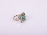 an emerald and diamond cluster ring