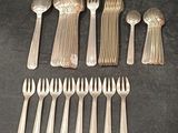un grand nombre de fourchettes et de cuillères posées sur une table