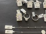 many different types of necklaces and bracelets on the table
