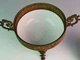 a small mirror sitting on a table next to a plate
