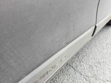 a close up of a car ' s door handle and the side of the car
