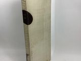 an old book sitting on top of a white table next to a white wall