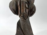 sculpture of a woman ' s head on a stone base on a white background