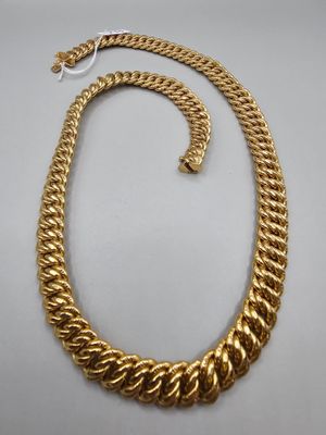 a gold necklace and bracelet set on a white background