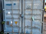 a blue shipping container sitting in front of a building
