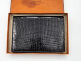 an image of a black wallet in a box on a white surface