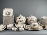 many plates and cups and saucers on the table