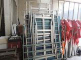 a lot of chairs that are stacked up in a room