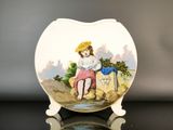 a plate with a picture of a girl sitting on a rock