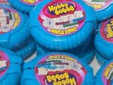 a pile of blue and pink doughnuts on a table