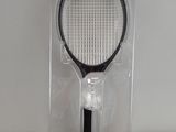 a tennis racket in the packaging on the table