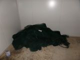 a pile of garbage on the floor in the corner of a room