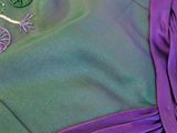 a purple dress with a green design on it
