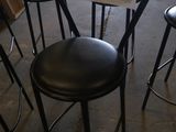 four stools that have a price tag on them