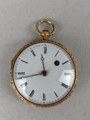 a gold pocket watch with roman numerals on the face