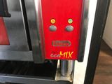 a close up of a red and black oven with a sign on it