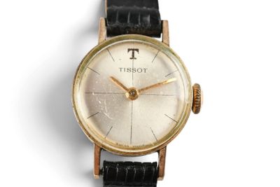a gold wrist watch with a black leather strap