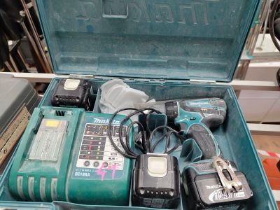 a green tool box with tools in it on a table