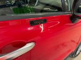a red car that has a sticker on the door