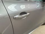 a close up of a car door handle with a sticker on it