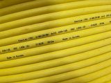 a close up of a yellow hose with a lot of words on it