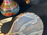 a table that has a table tennis racket and a ball on it