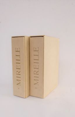 two books in a box on a white surface