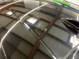 a reflection of a car in a mirror in a garage
