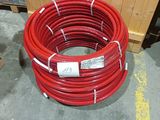 a stack of red hoses sitting on the floor