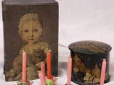 three candles and a box with a picture of a baby