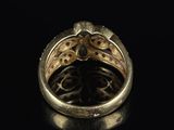 a close up of a gold ring on a black surface