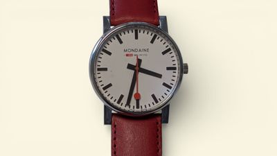 a close up of a wrist watch with a red strap