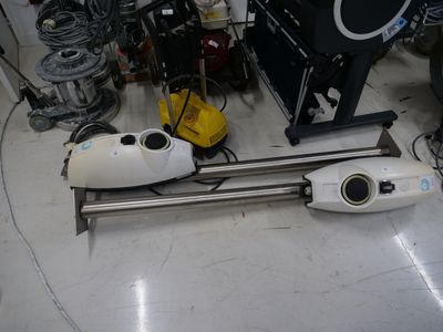 a vacuum that is sitting on the floor in a room