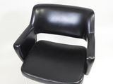 a black chair that is sitting on a white surface