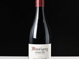 a bottle of red wine sitting on a table