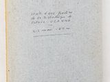 an old book with writing on it sitting on top of a table