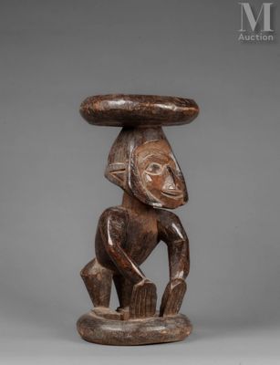 a wooden sculpture of a man with a hat on his head