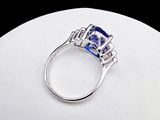 an image of a diamond and sapphire ring on a white surface