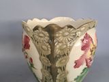 a white bowl with flowers on it on a table