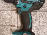 a close up of a cordless drill on a tiled floor