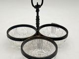 two black and clear glass bowls with handles on a white surface