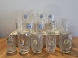 a lot of beer glasses sitting on a wooden table