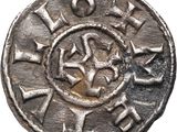 a close up of a silver coin with a star on it