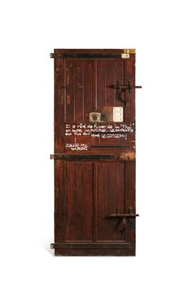 an old wooden door with writing on the side of it