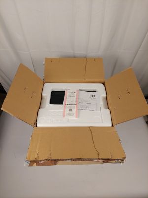 a box with a laptop inside of it on a chair