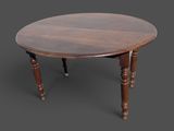 une vieille table en bois aux pieds tournés et au plateau rond