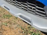 a close up of the front bumper of a blue car