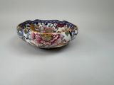 a close up of a bowl with flowers on it