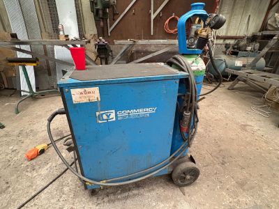 a blue machine that is sitting in a garage